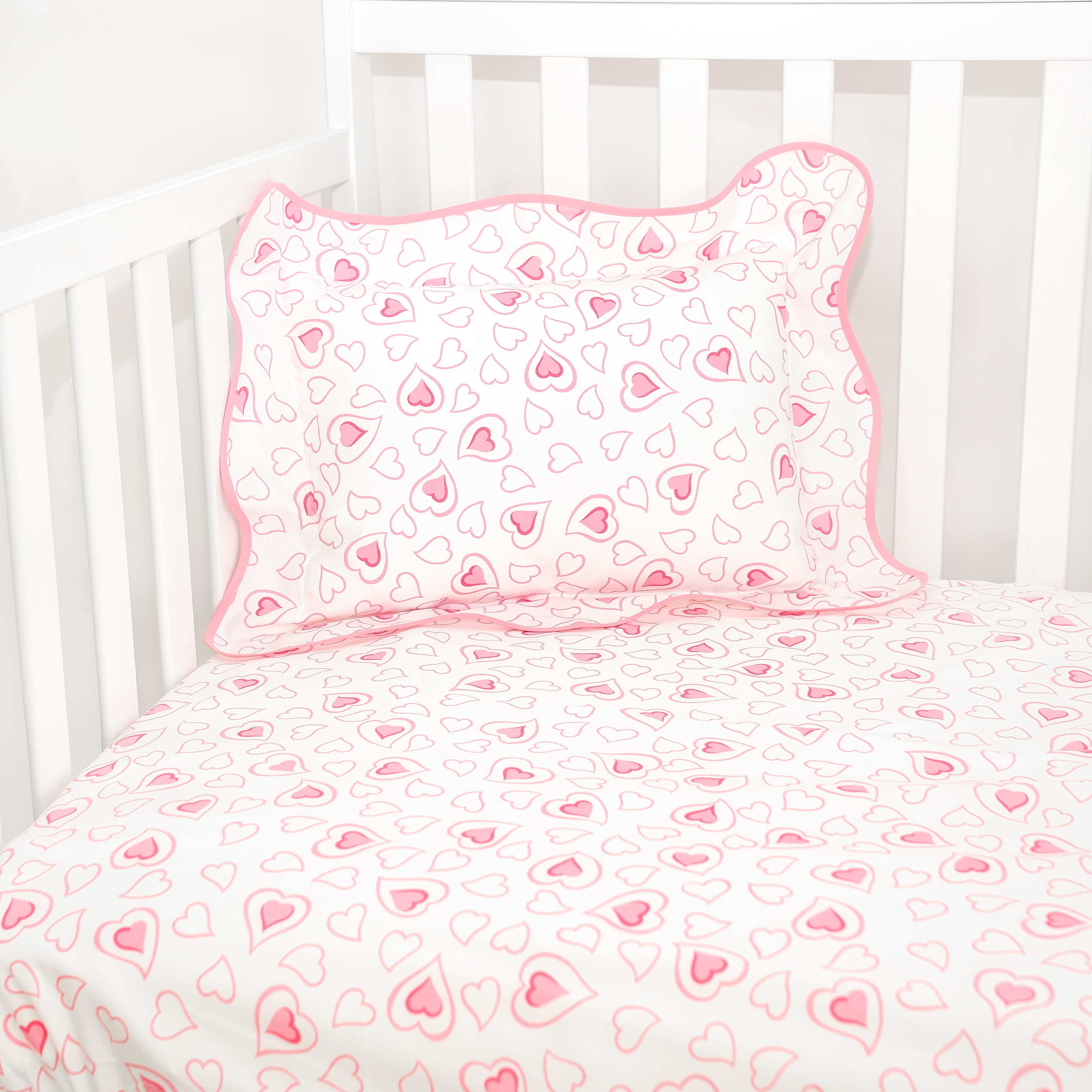 pink double hearts pattern fitted sheet in crib with boudoir sham