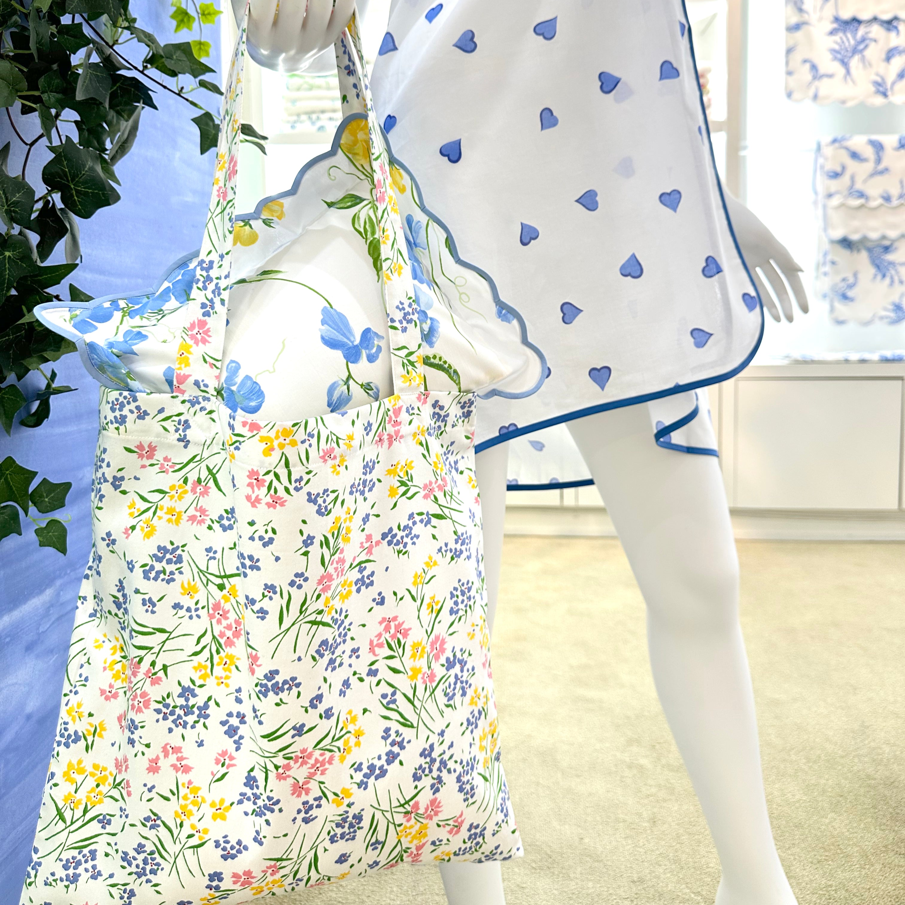 Person wearing a floral dress with a blue heart pattern in a room.
