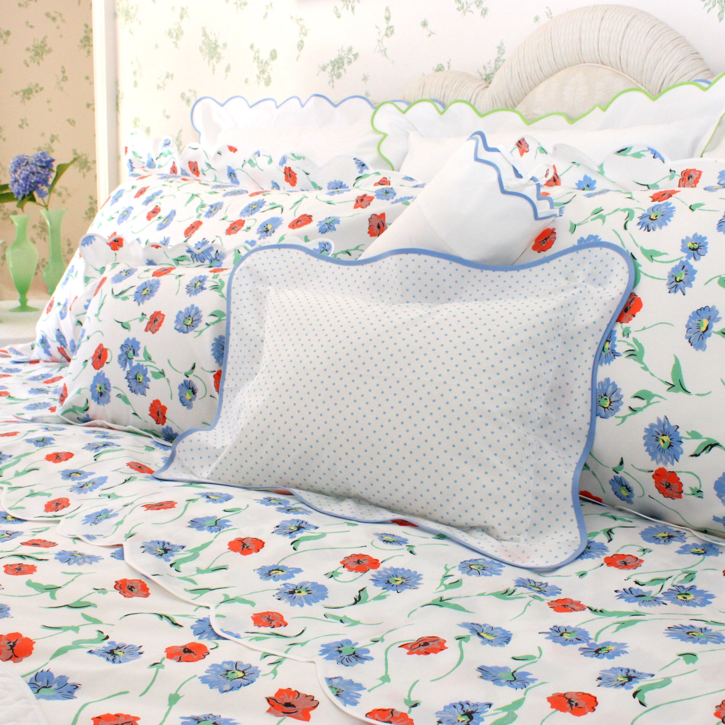 Floral bedding set with a white pillow on a bed