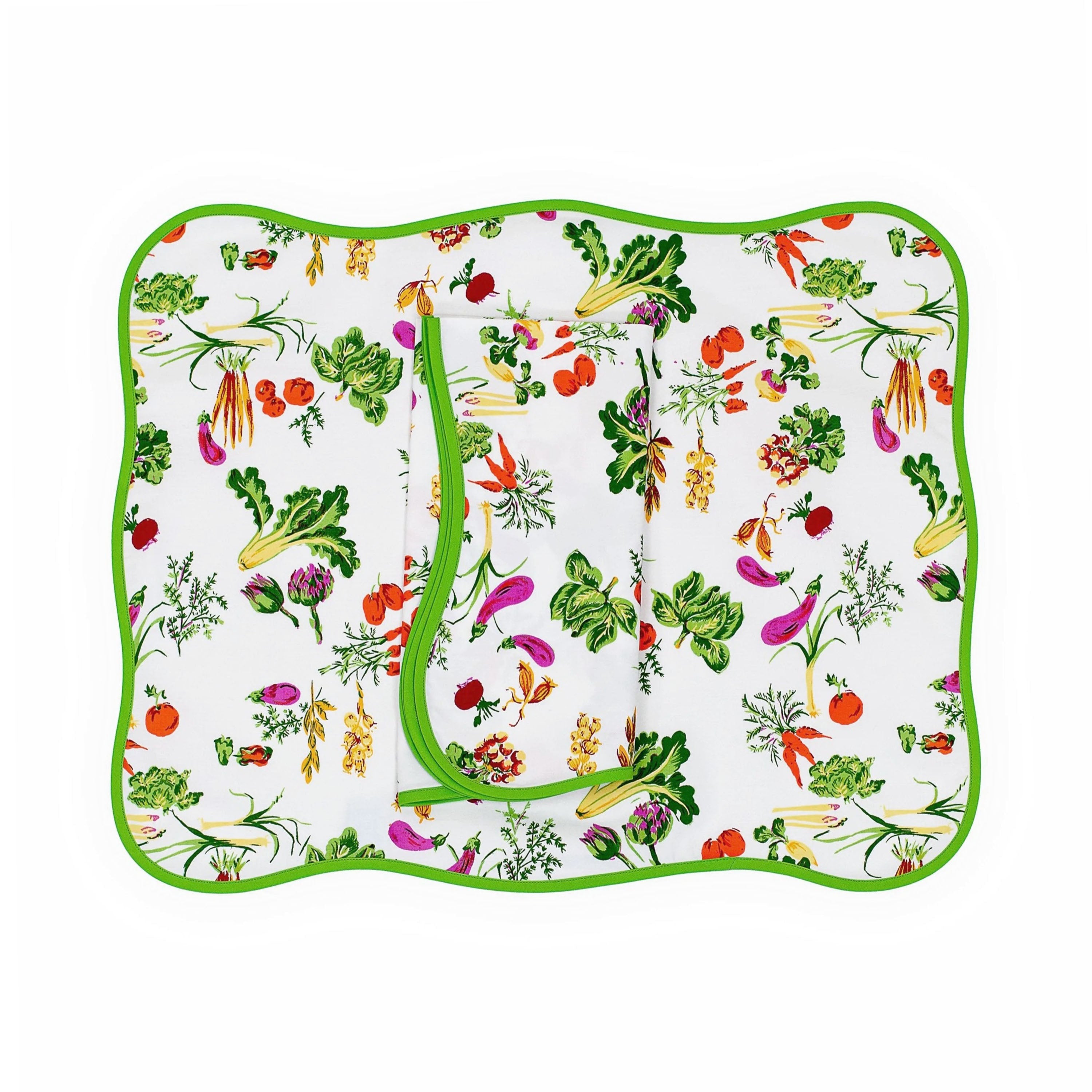 Colorful garden vegetables, orange carrots, lettuce, eggplant and more, Légumes print, shown on placemat with a folded napkin, finished with a green bias, on a white background.