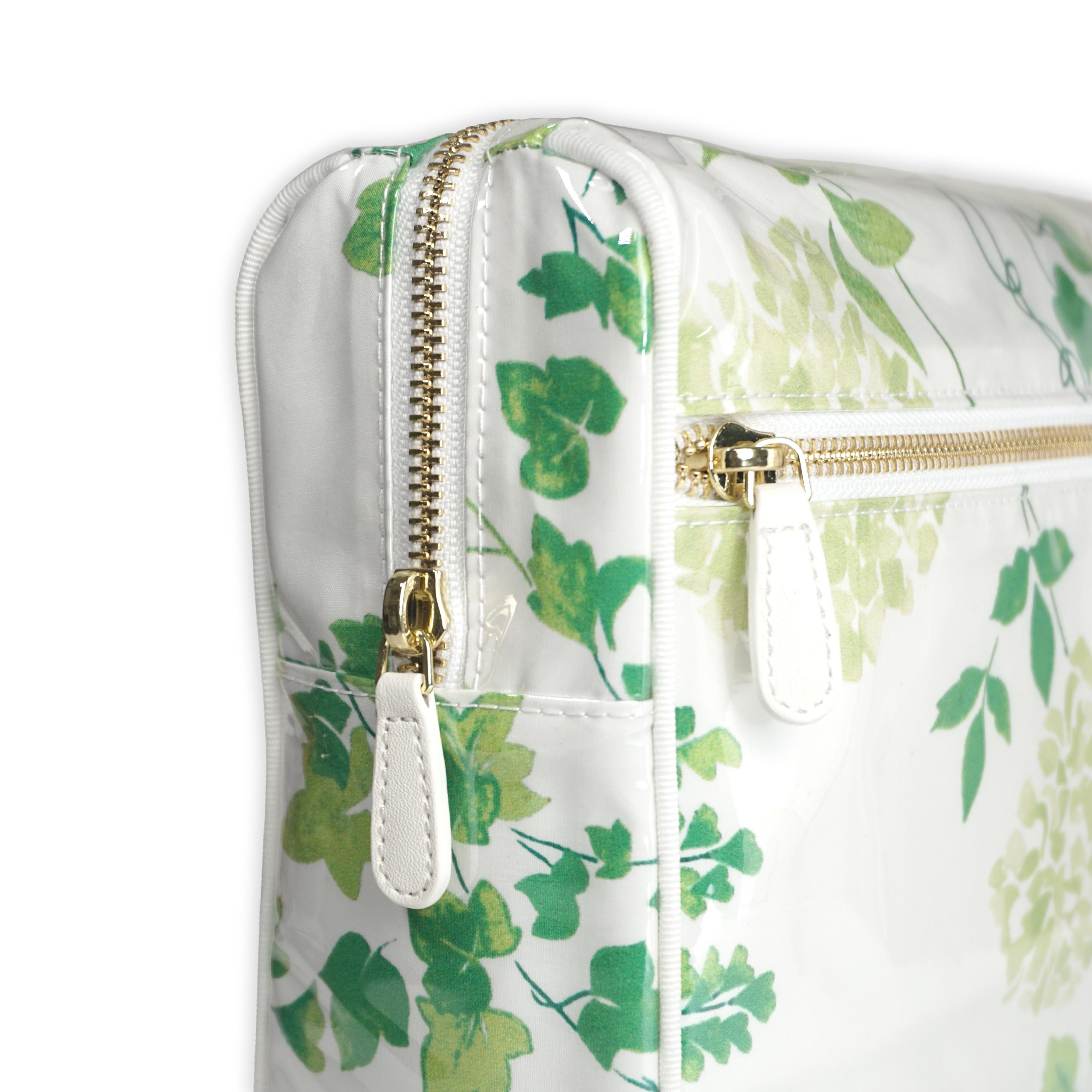 Large cosmetic bag featuring green hydrangea motifs in Mariage, with a brass zip closure along the top and an exterior front zip pocket.