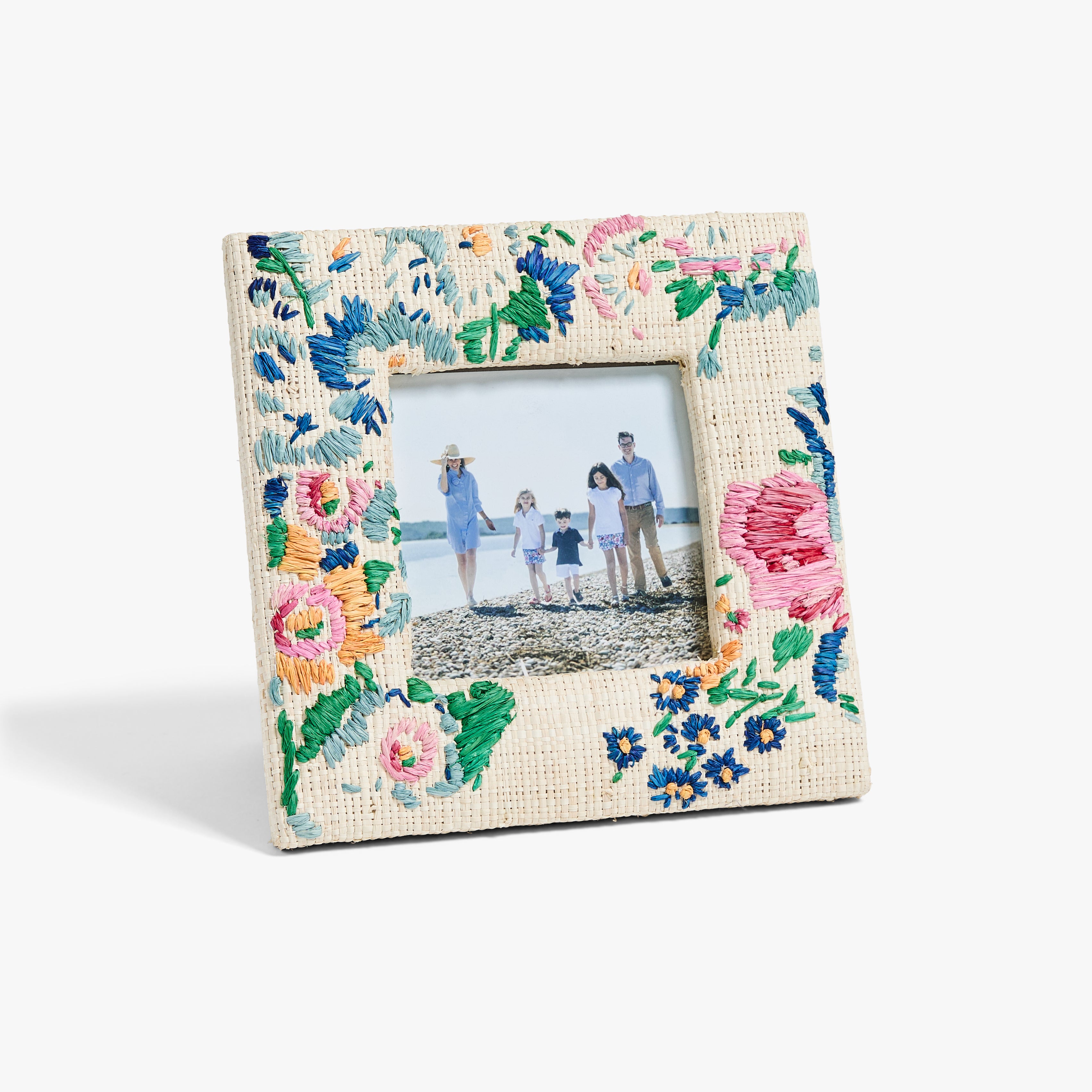 Floral embroidered picture frame with a family photo inside on a white background