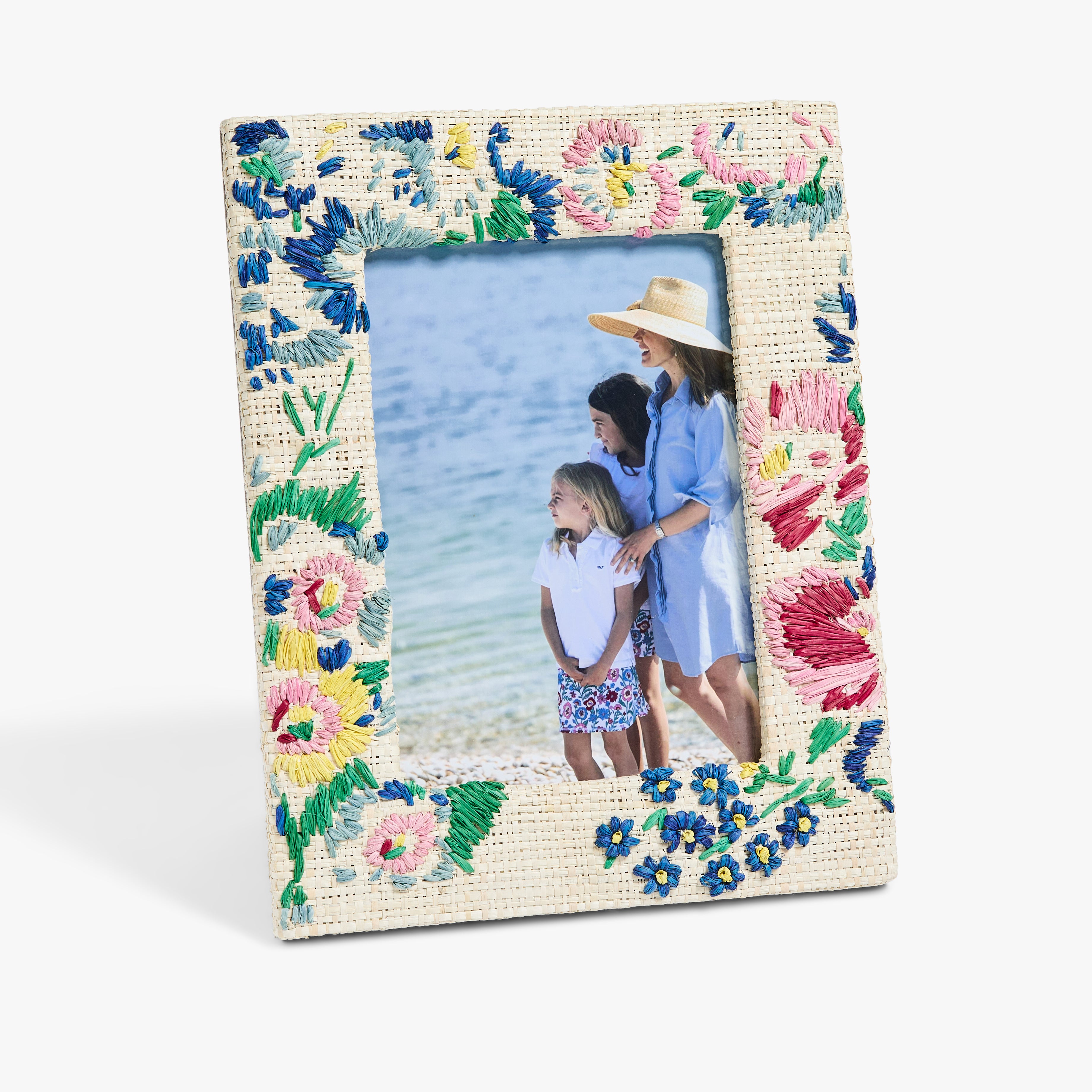 Floral embroidered picture frame with a family photo inside on a white background