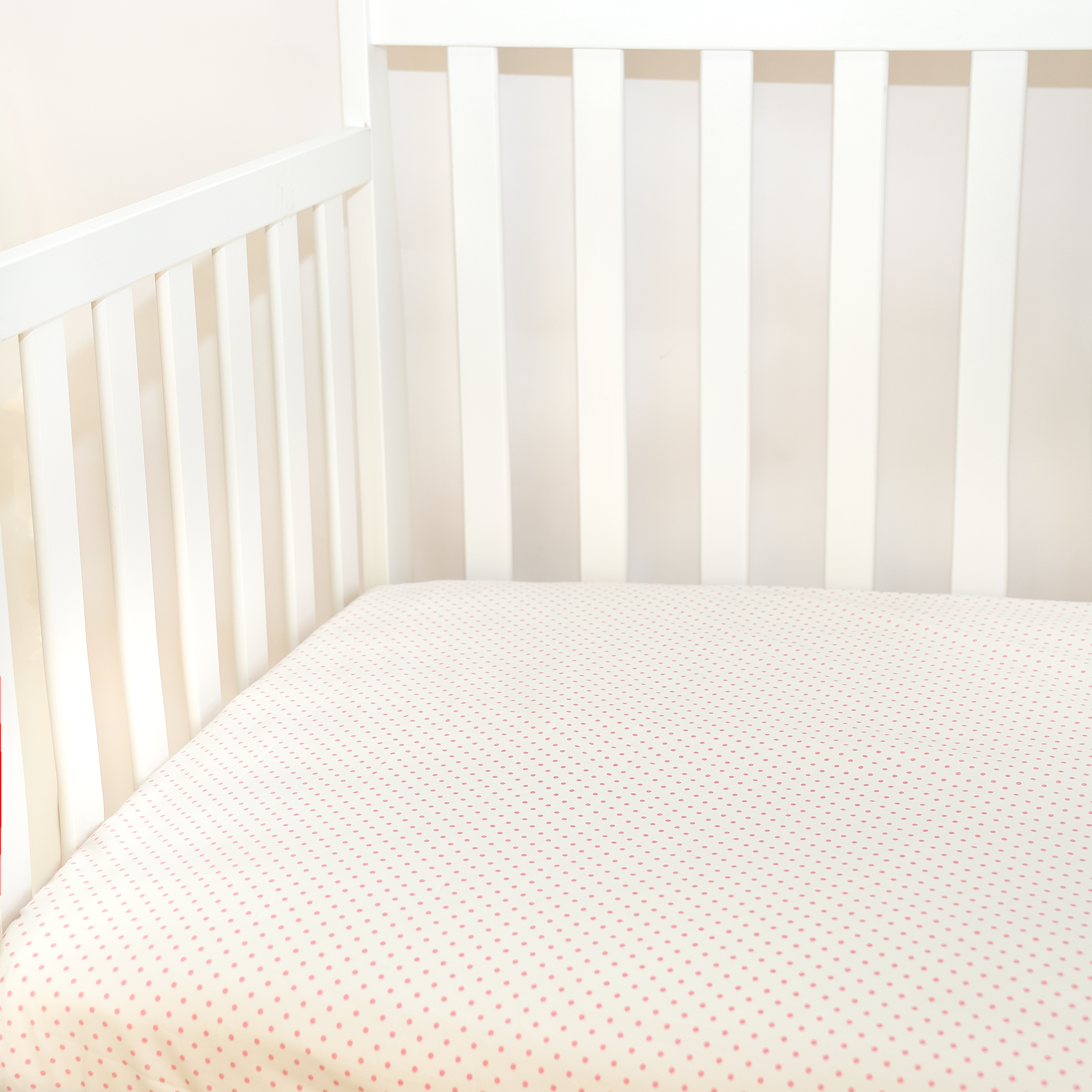 pink dots pattern fitted sheet in crib