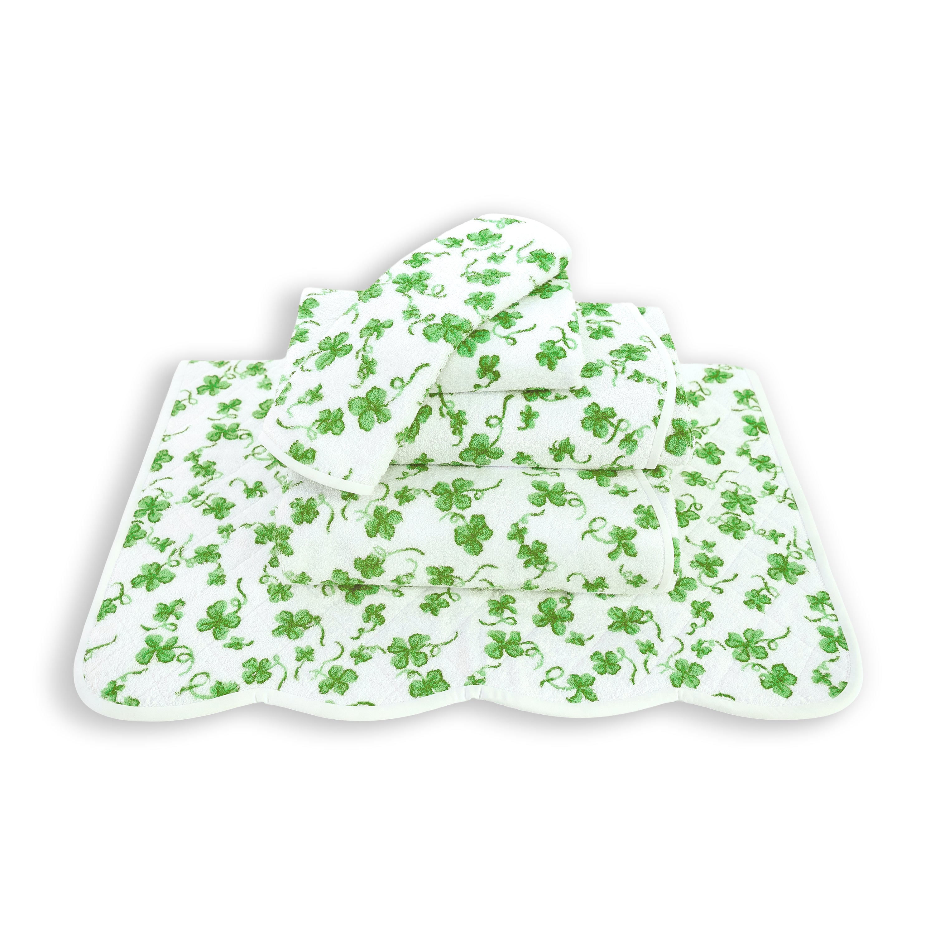 Printed green clovers, Trefles Print, Folded Towel stack. Showing 1 of each size, from bottom to the top: Bathmat, Bath Sheet, Bath Towel, Hand Towel and Washcloth on a solid white background.