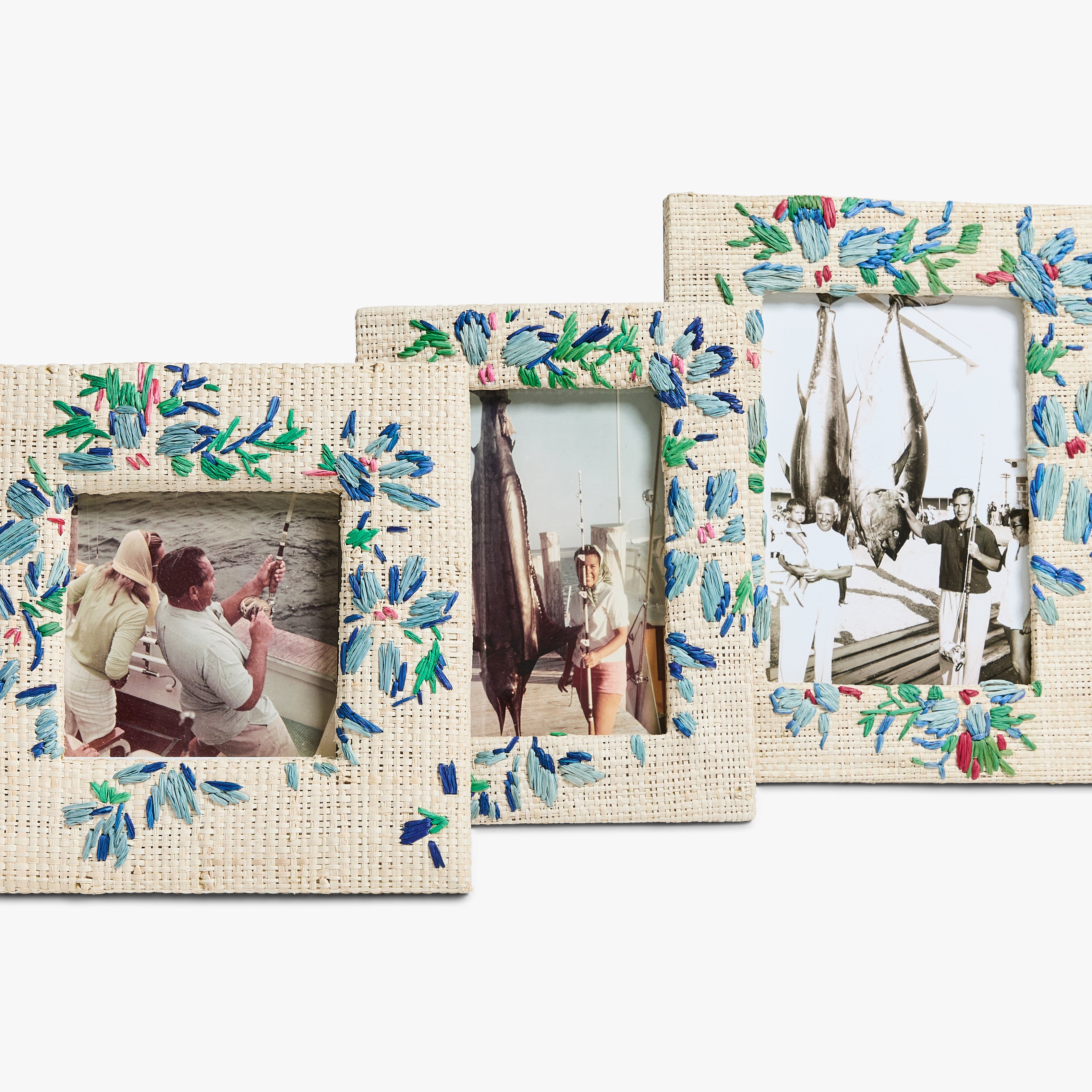 Three framed vintage photos show people fishing and displaying large catches, each frame decorated with blue and green floral embroidery