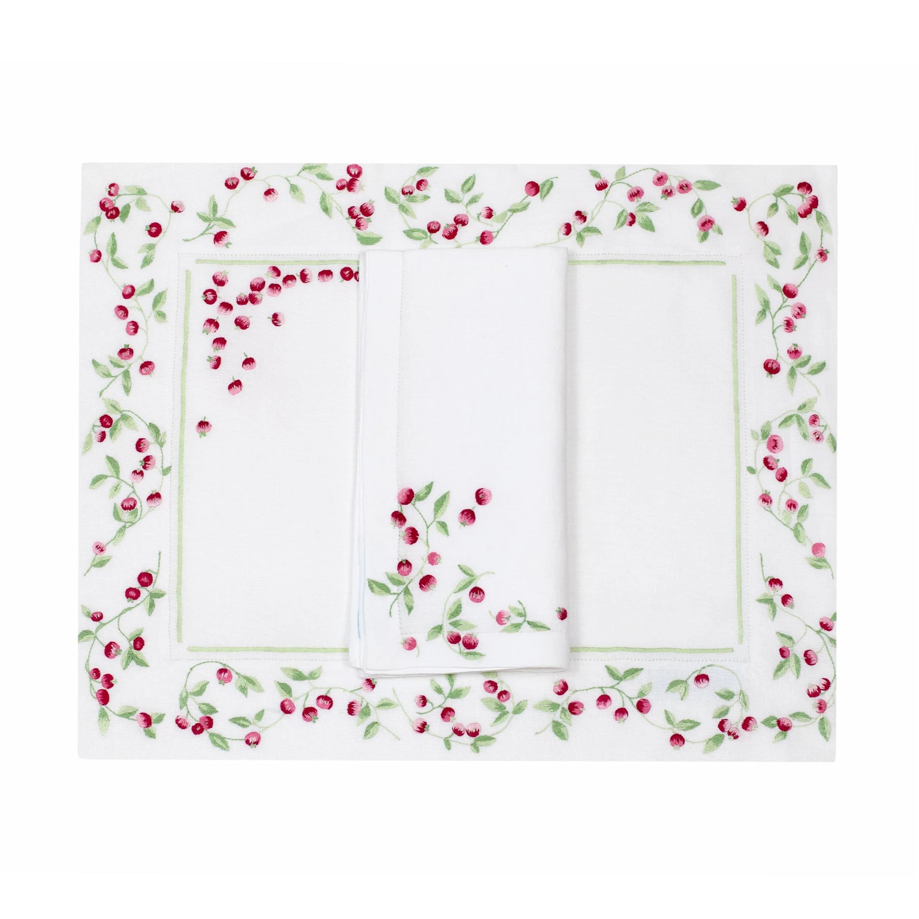 Embroidered small bunch of deep and light pink berries and green small leaves/stems, Baies Roses Embroidery, shown on placemat with a folded napkin, finished with a hemstitch on white linen, on a white background.