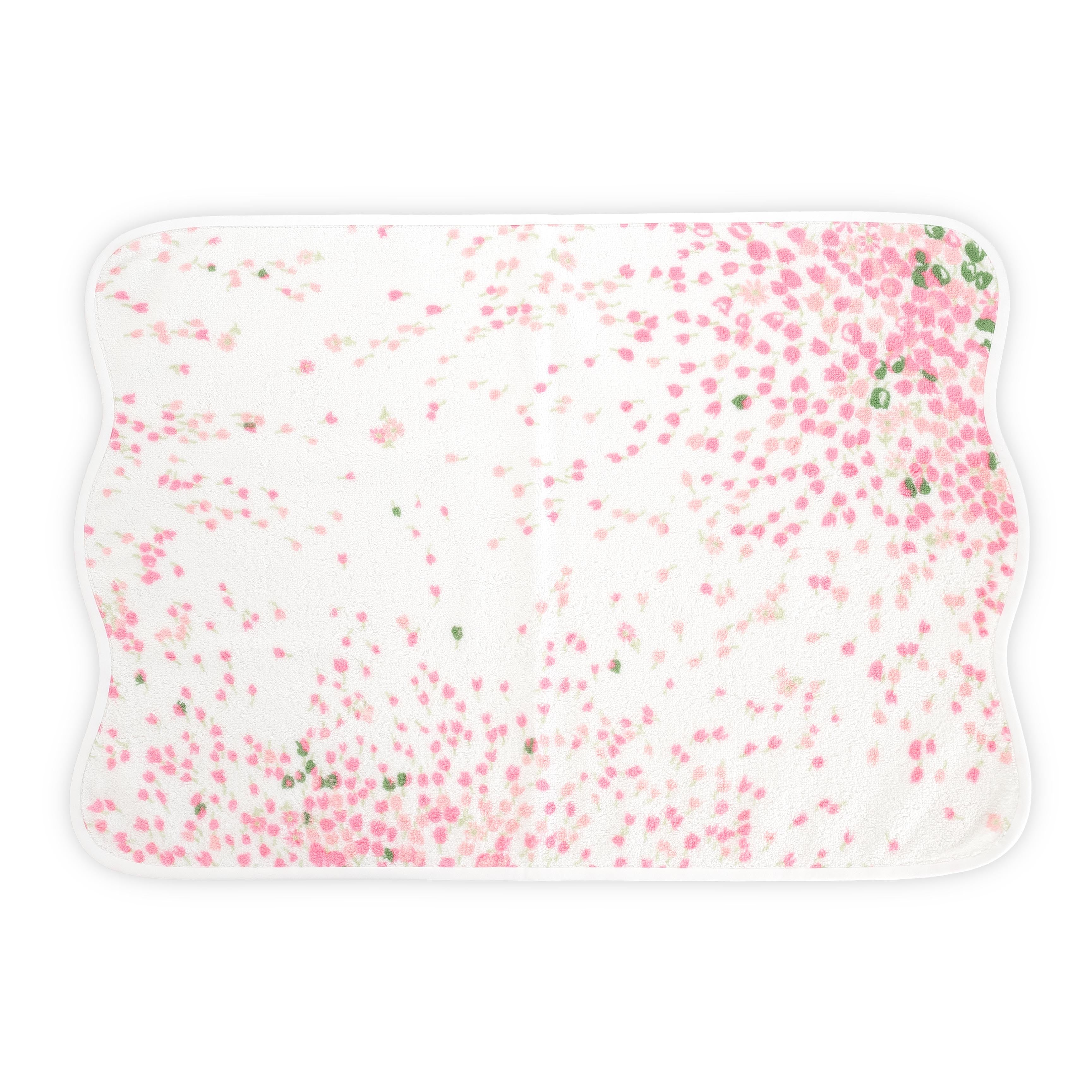White Hand towel with pink and green floral print. Hand towel shows with a wavy white bias. On a white background.
