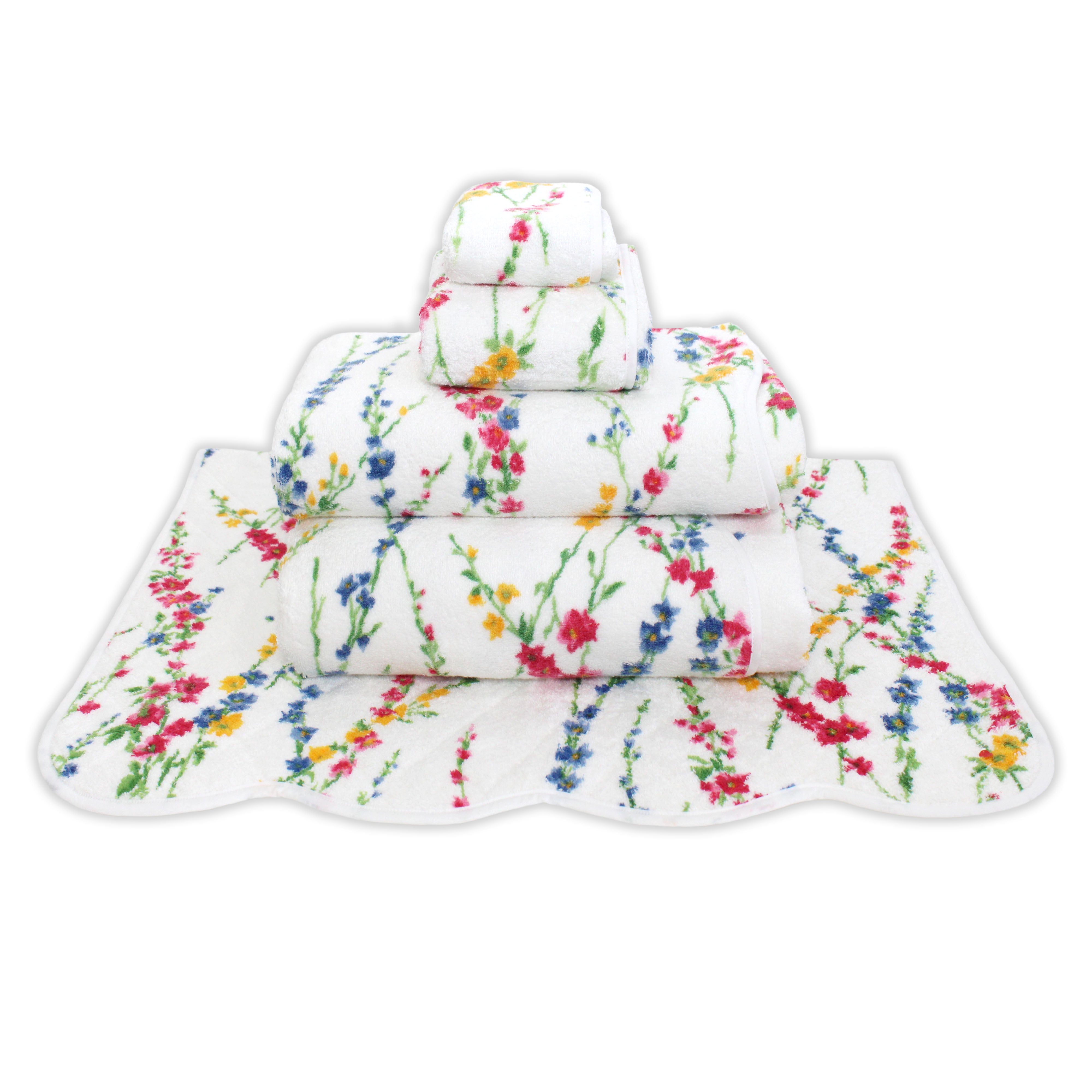 Printed multi color florals; pink, blue and yellow with green leaves/stems, Brindilles Print, Folded Towel stack. Showing 1 of each size, from bottom to the top: Bathmat, Bath Sheet, Bath Towel, Hand Towel and Washcloth on a solid white background.