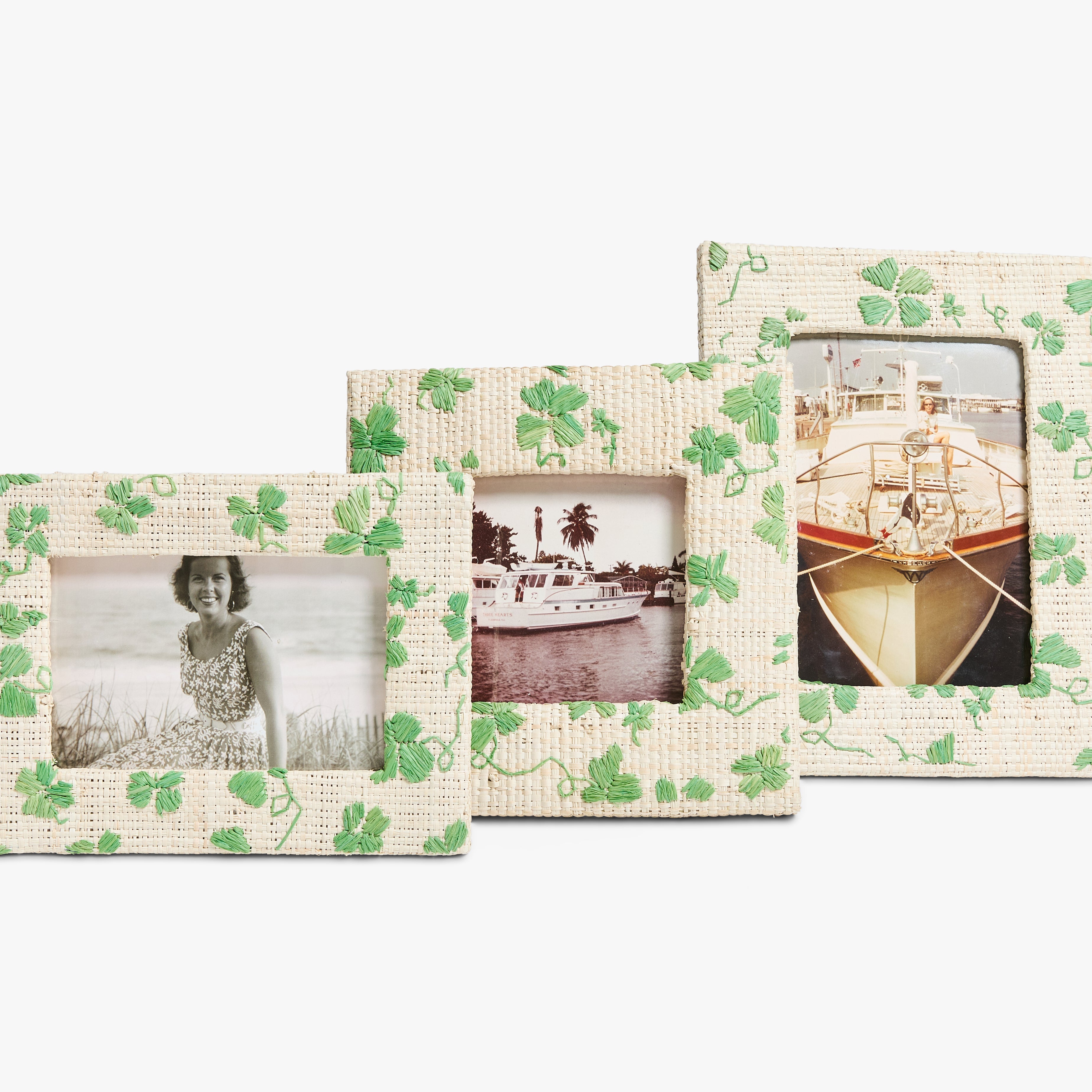 Three photo frames with clover patterns hold vintage black-and-white images. The left frame shows a smiling woman, the middle a boat, and the right a ship's bow.