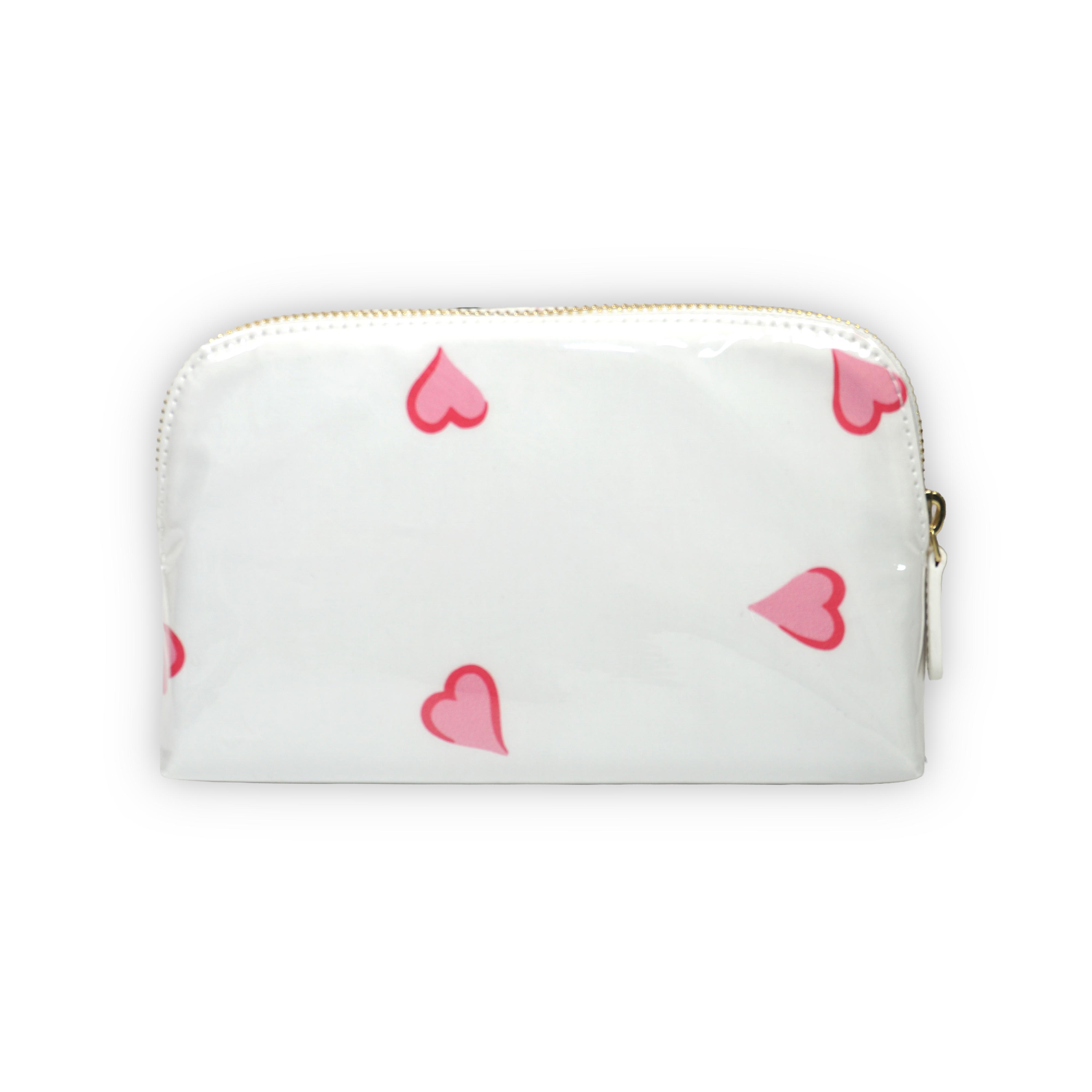 Small white cosmetic pouch featuring scattered pink heart motifs, finished with a gold-tone brass zip closure.