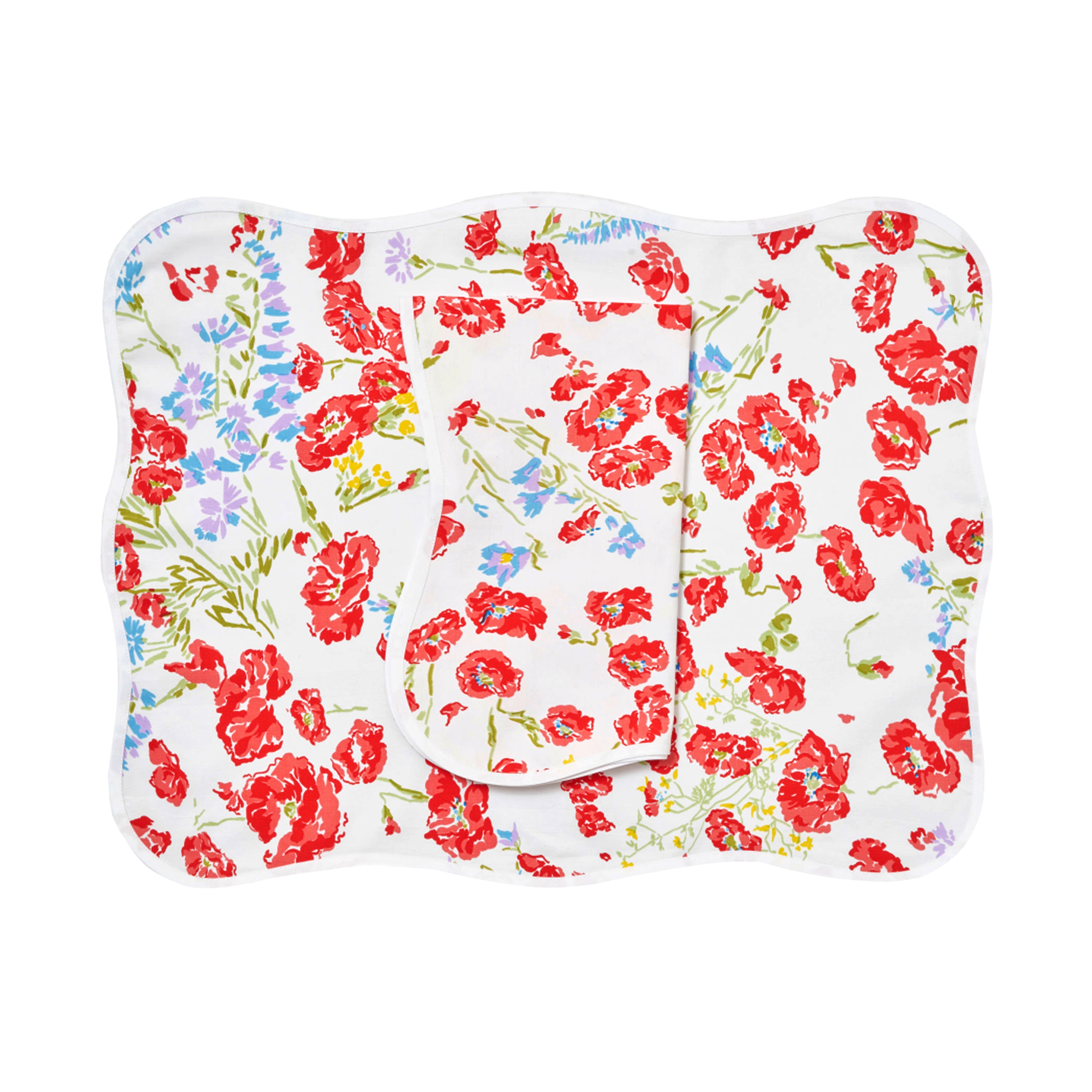Red florals with mini blue/purple flowers, green stems/leaves, Coquelicots print, shown on placemat with a folded napkin, finished with a wavy white bias, on a white background.