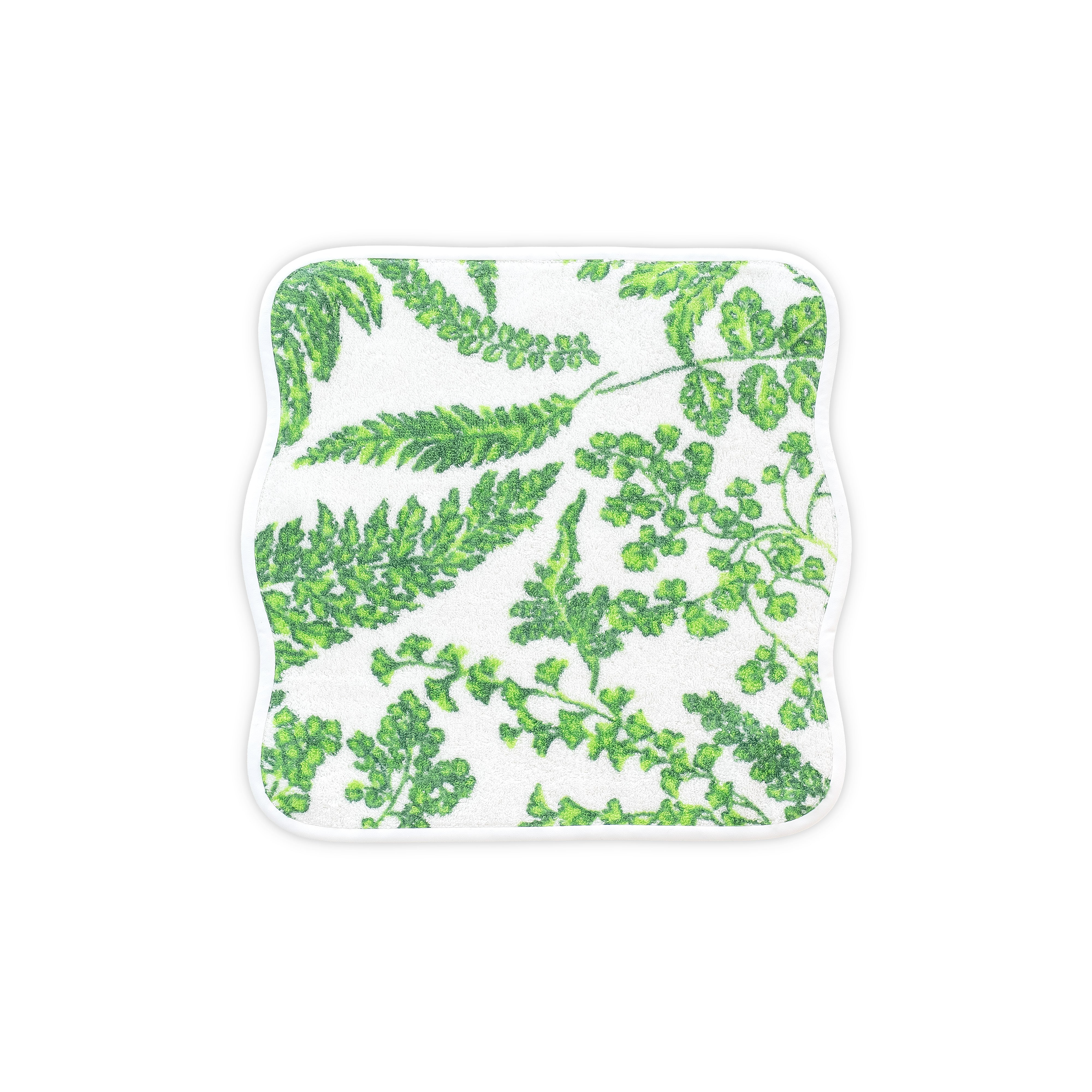 White washcloth with green floral print. Washcloth shows with a wavy white bias. On a white background.
