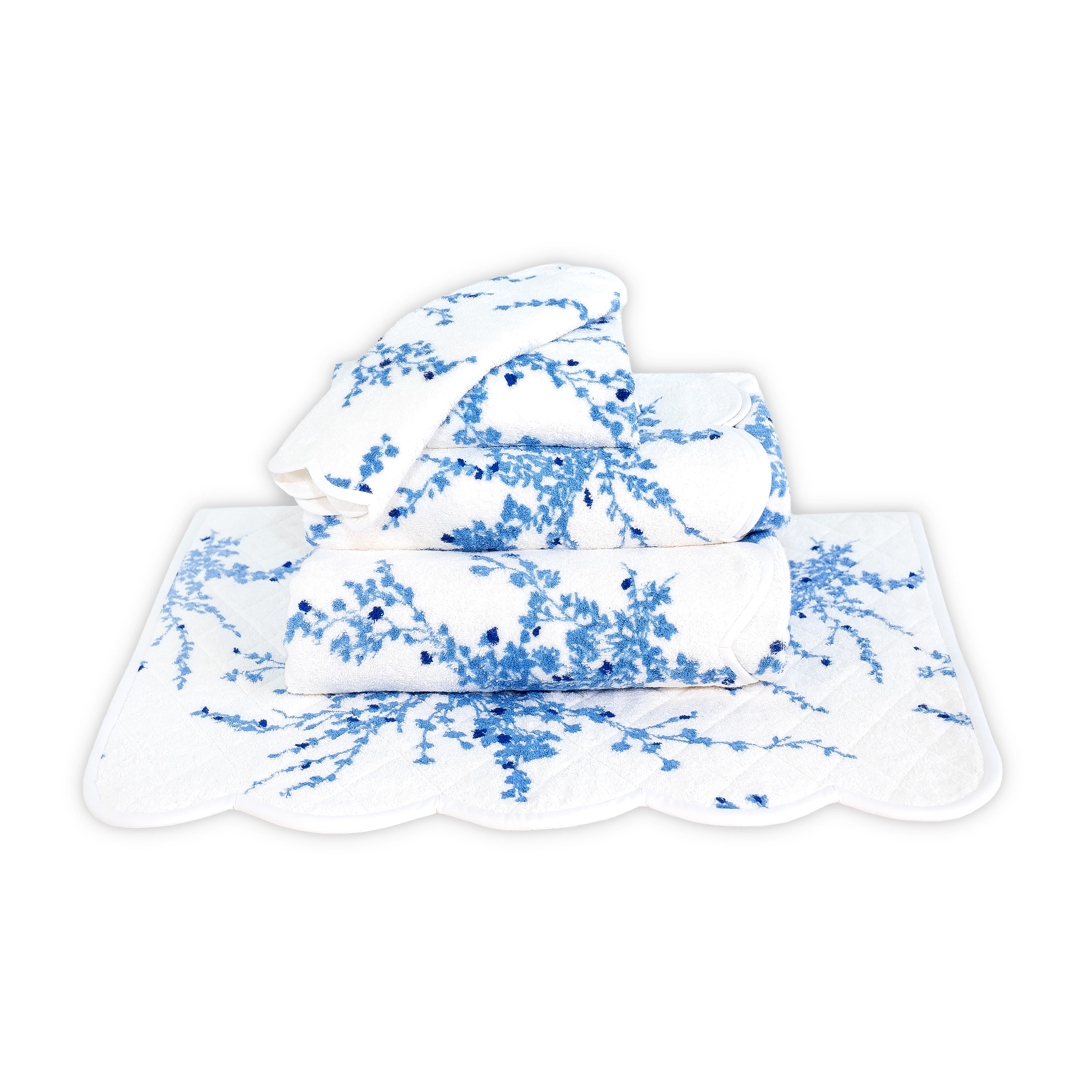Printed blue florals, Folded Towel stack. Showing 1 of each size, from bottom to the top: Bathmat, Bath Sheet, Bath Towel, Hand Towel and Washcloth on a solid white background.
