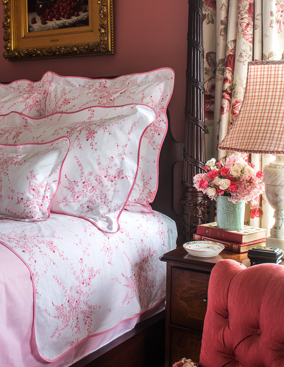 Jete de Fleurs Pink bed liens in room with pink accents; chair, flowers, etc.