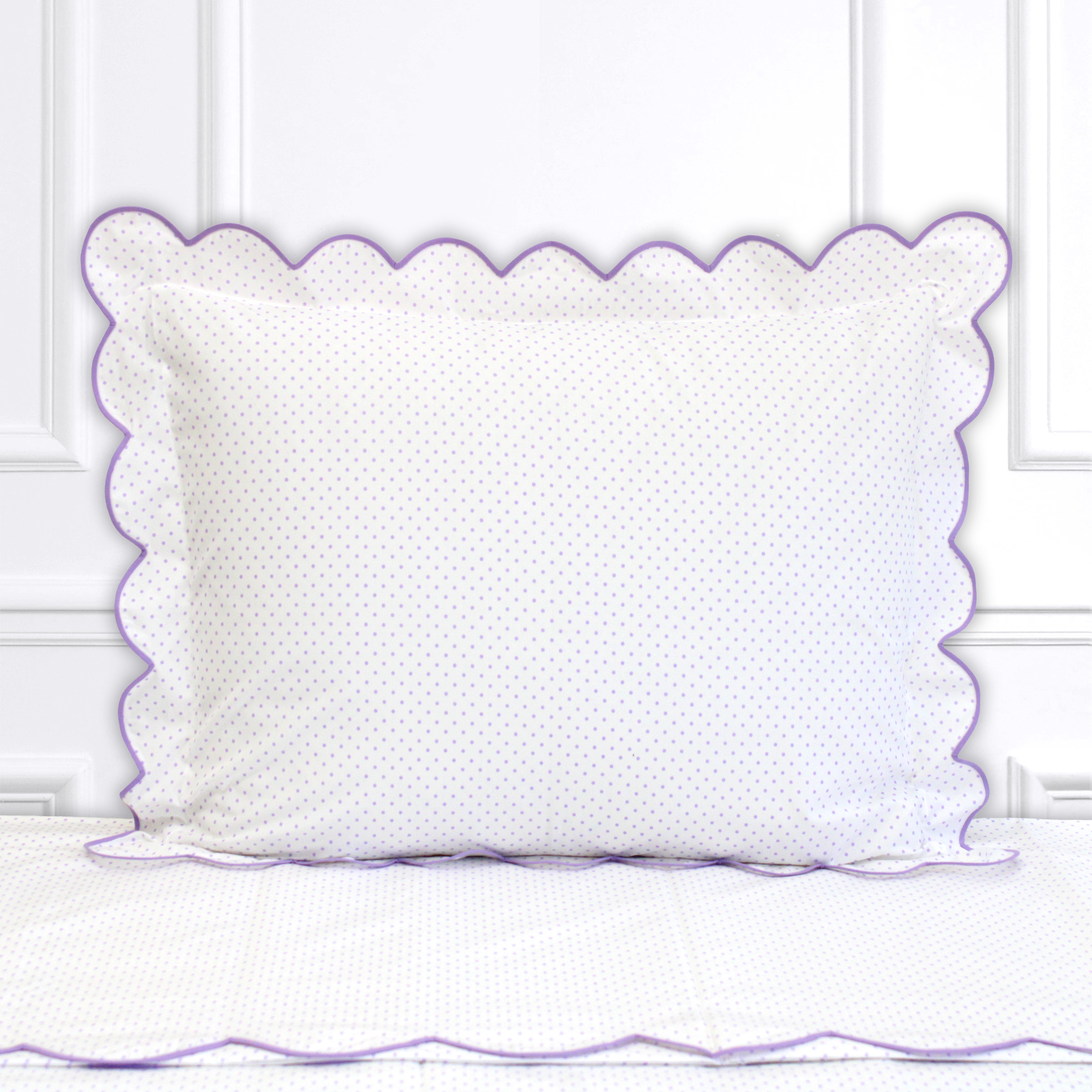 Lilac polka dots, Mini Confettis print shown on a Standard Sham with a scallop lilac bias, on top of matching bed sheet with a white panel background.