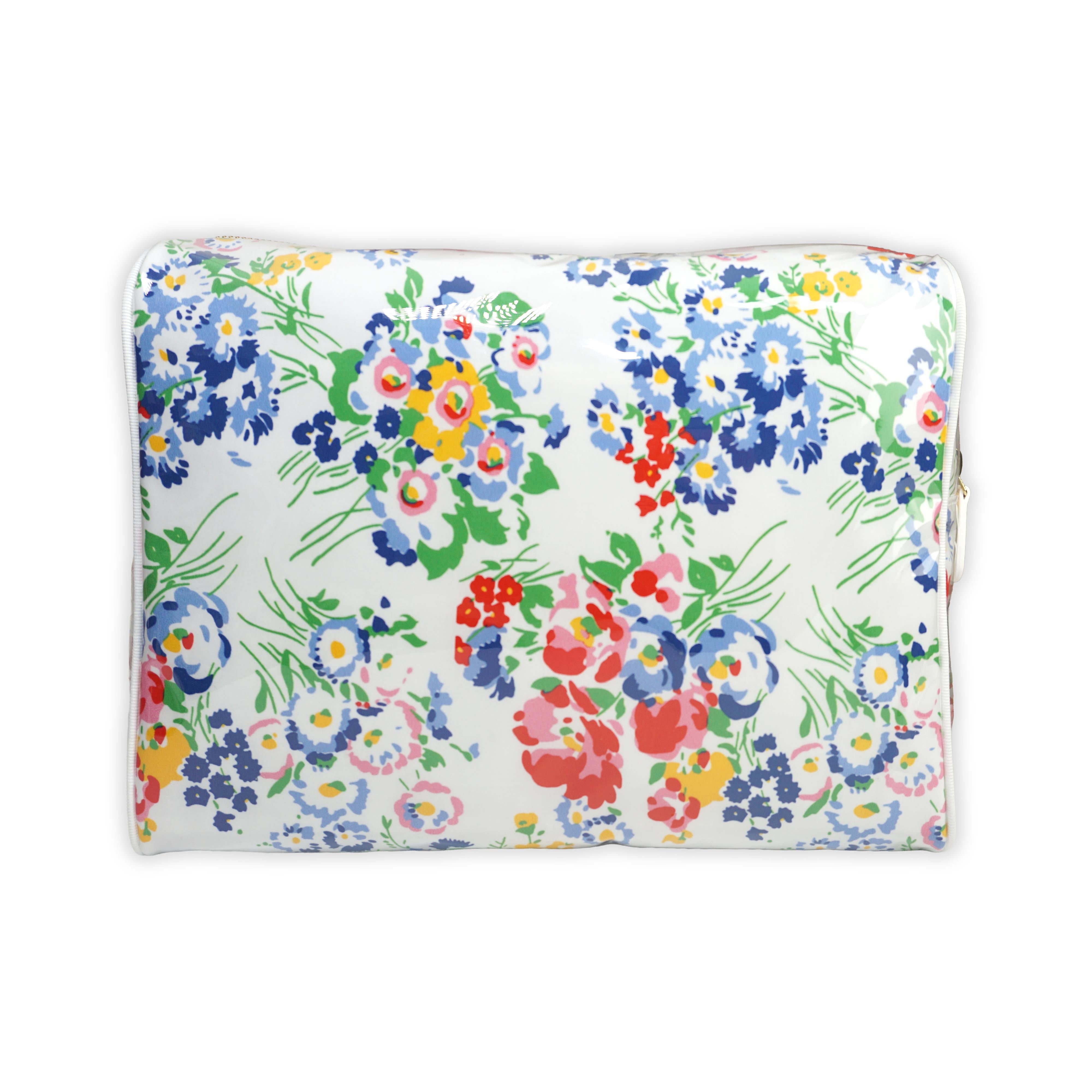 Large cosmetic bag featuring multicolored floral motifs in New York Mille Fleurs, with a brass zip closure along the top and an exterior front zip pocket.