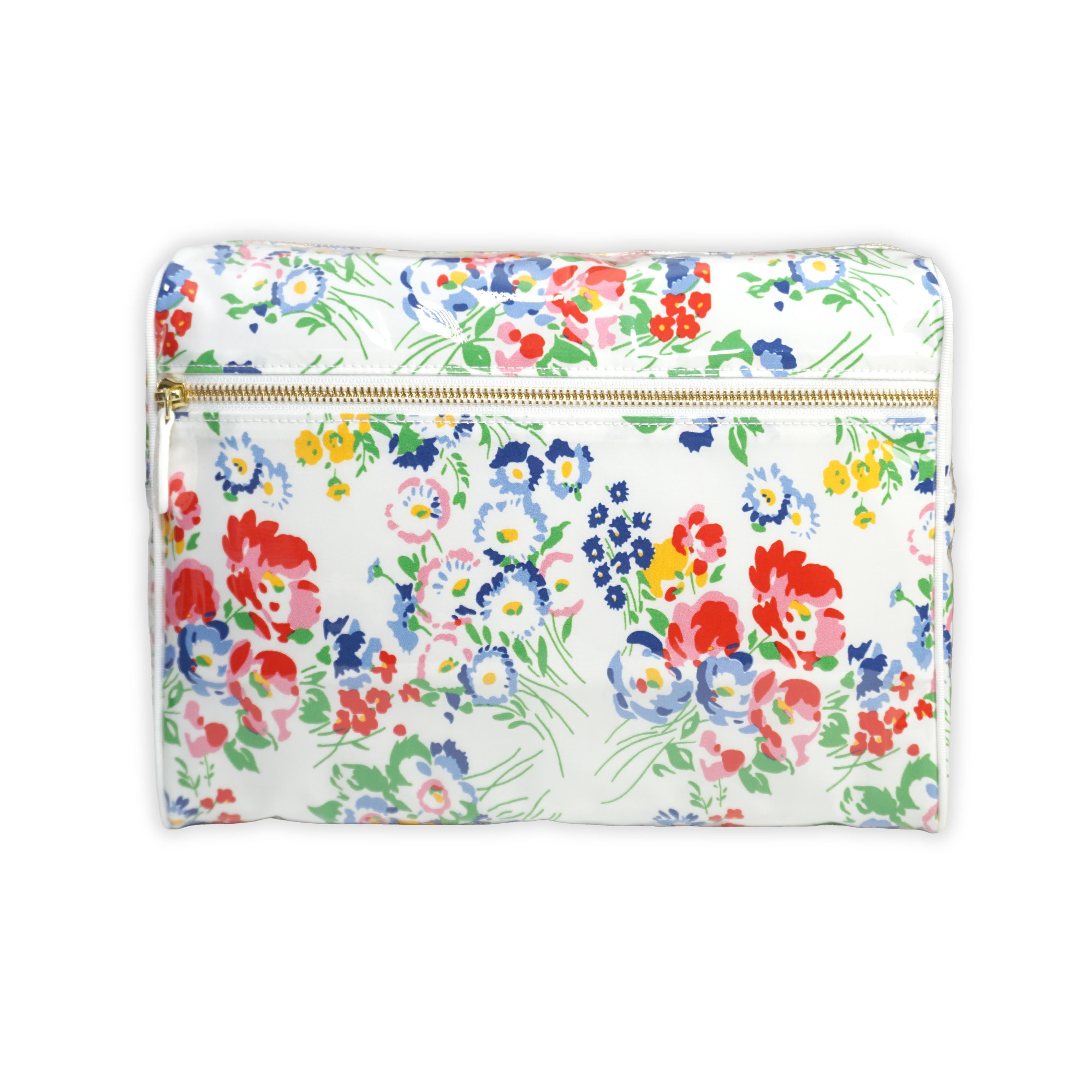 Large cosmetic bag featuring multicolored floral motifs in New York Mille Fleurs, with a brass zip closure along the top and an exterior front zip pocket.