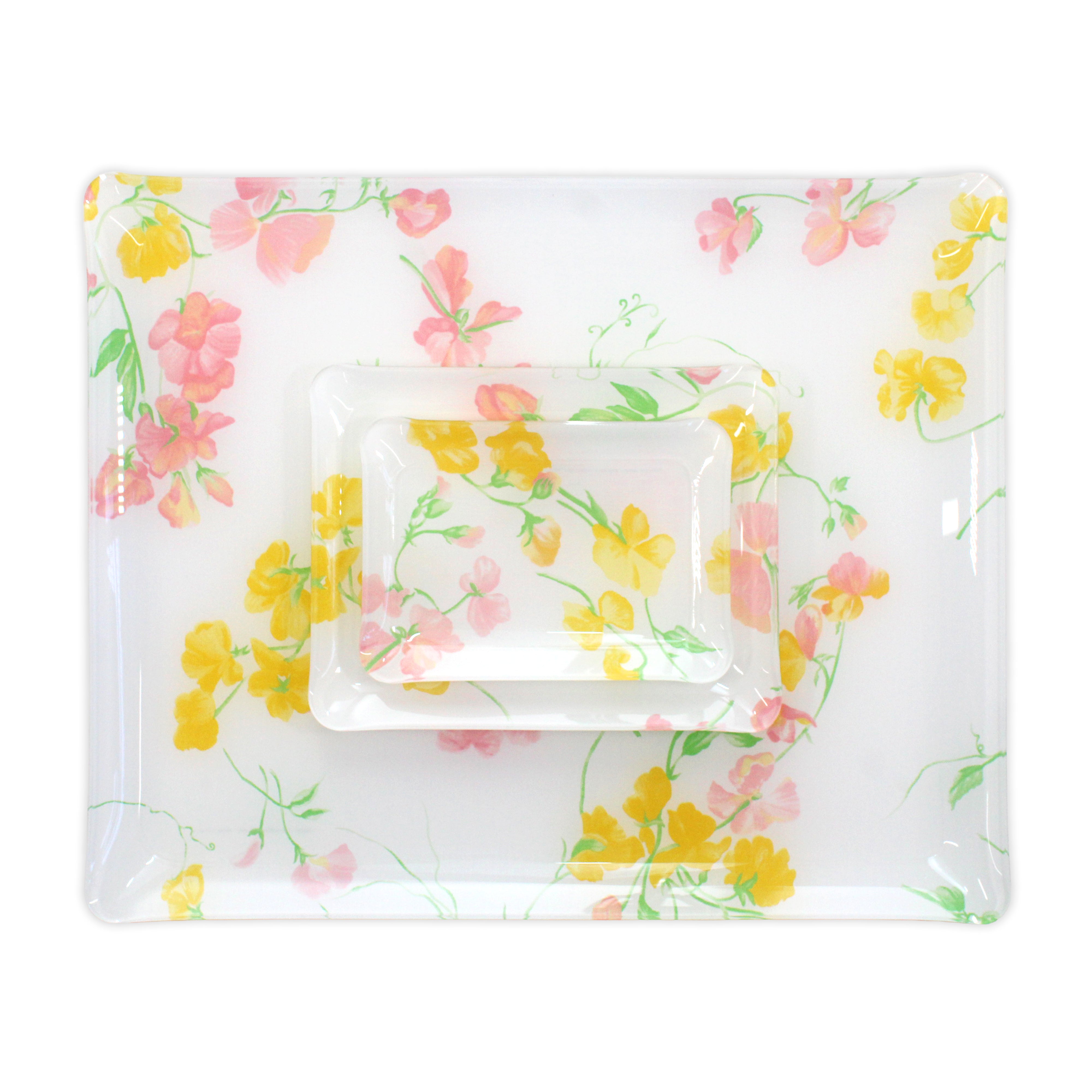 Printed Laminated Trays, group of all 3 trays, top to bottom: small, medium and large. Each tray in pink and yellow florals with green leaves/stems, Pois de Senteur Pink/Yellow print.