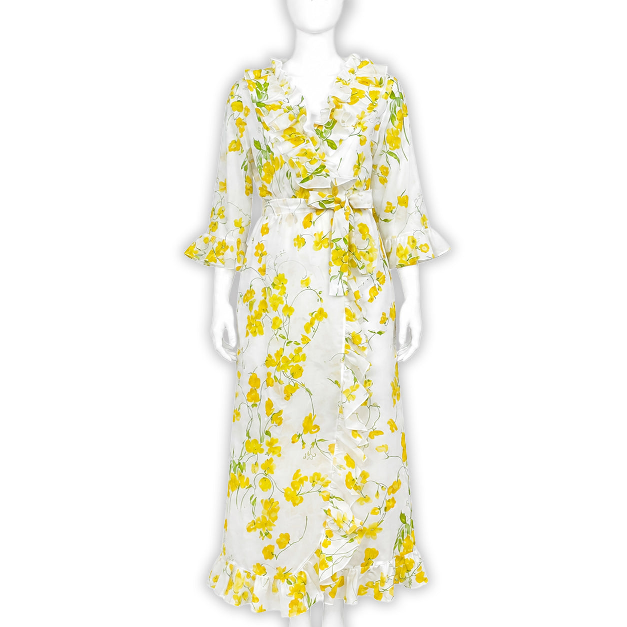 Yellow florals, sweet pea, on cotton voile bias cut long nightgown with waist tie and V-neck, ruffles in front, back and on sleeve cuffs. Displayed on mannequin with a white background.