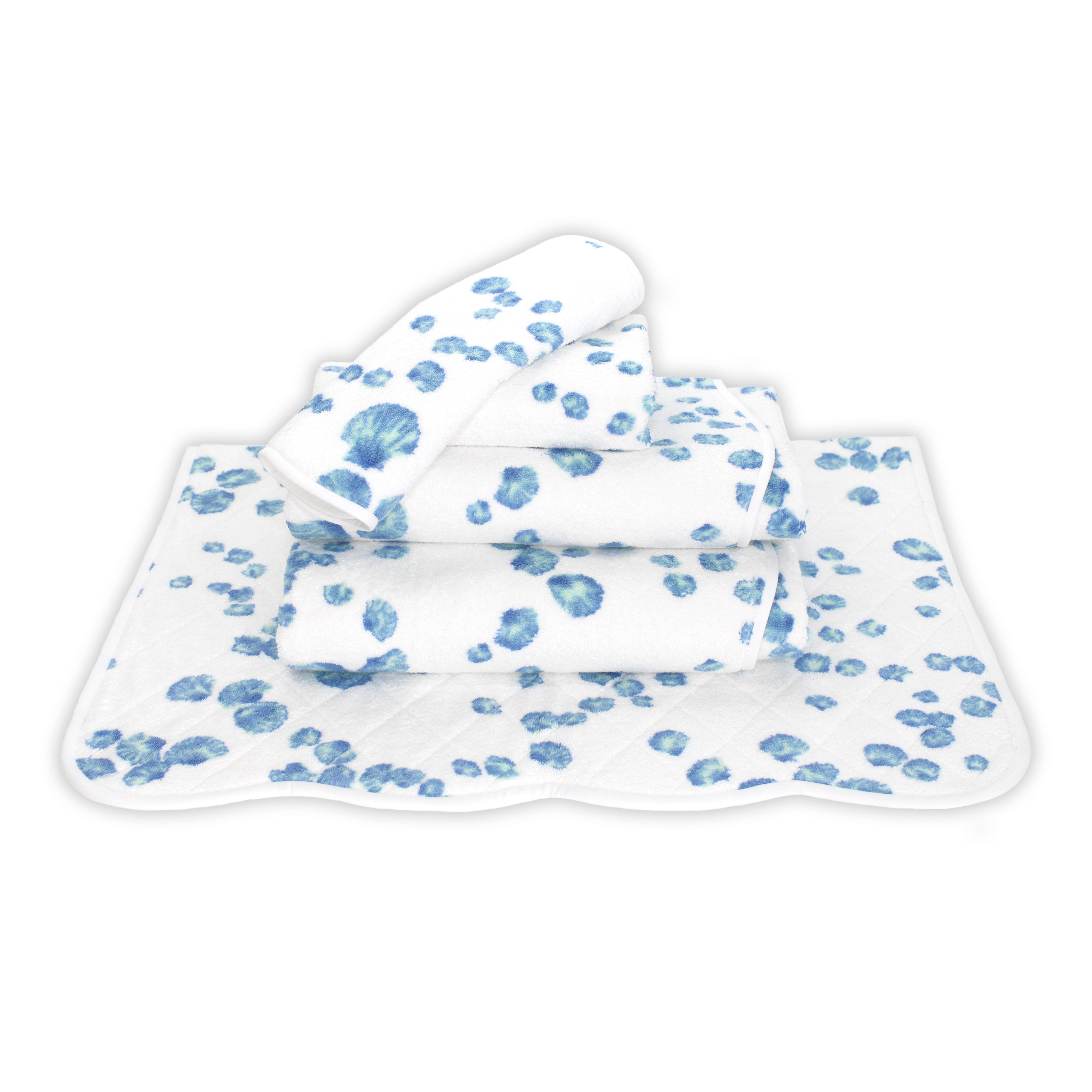 Printed blue shells Print, Folded Towel stack. Showing 1 of each size, from bottom to the top: Bathmat, Bath Sheet, Bath Towel, Hand Towel and Washcloth on a solid white background.