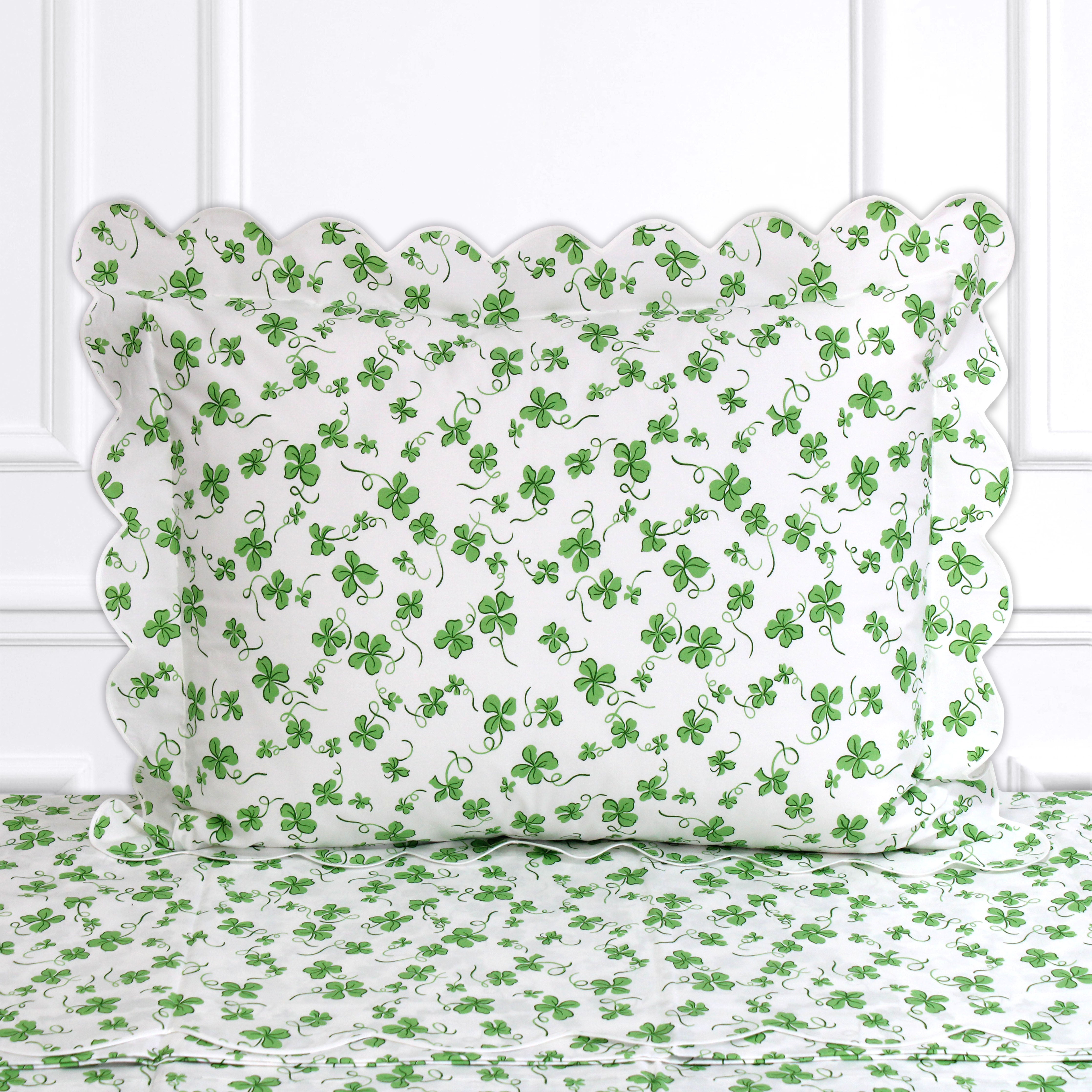 Green clovers, Trefles print shown on a Standard Sham with a scallop white bias, on top of matching bed sheet with a white panel background.
