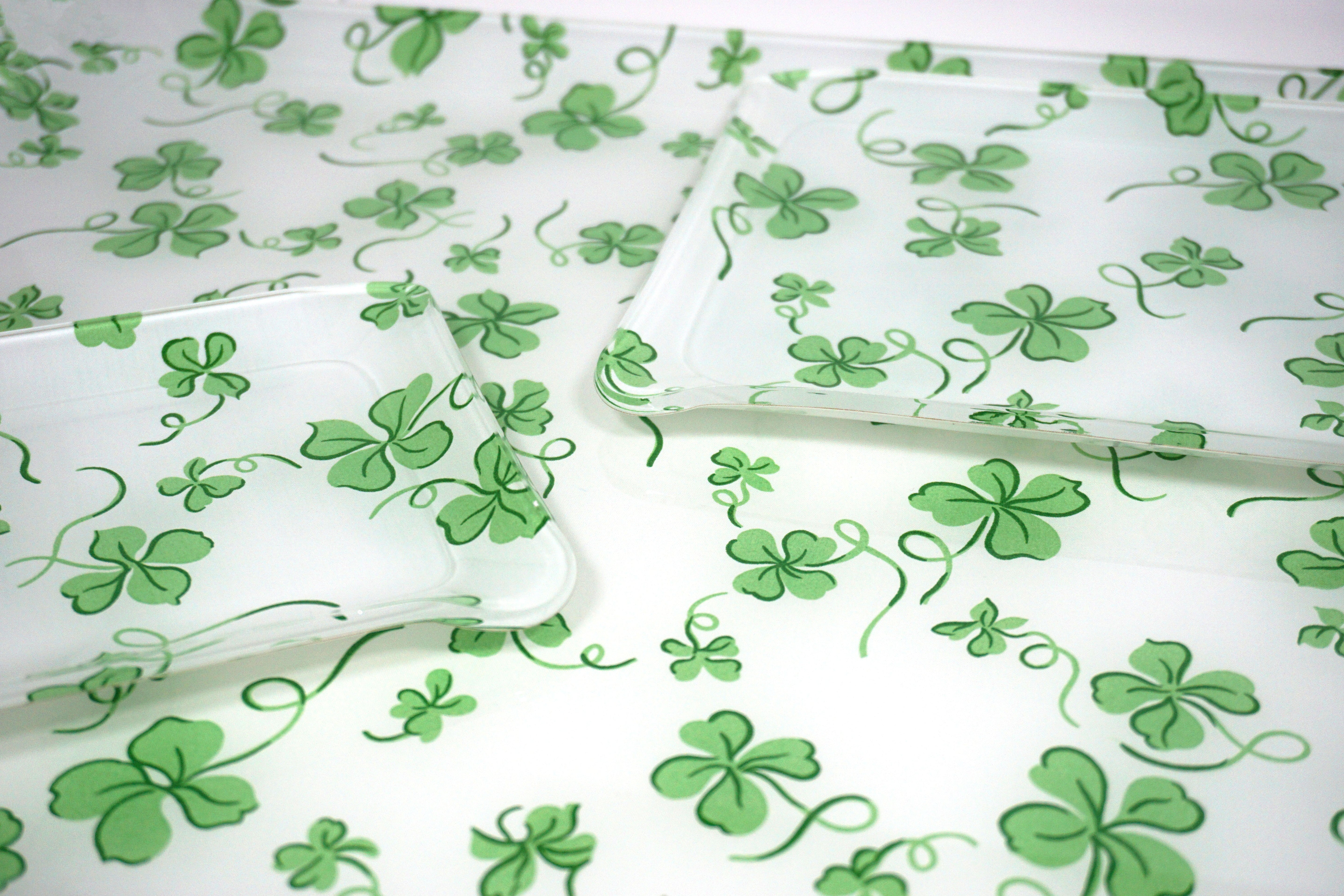 Printed Laminated Trays, side view of small and medium size trays on top of large tray. Each tray in green clovers, Trefles print.