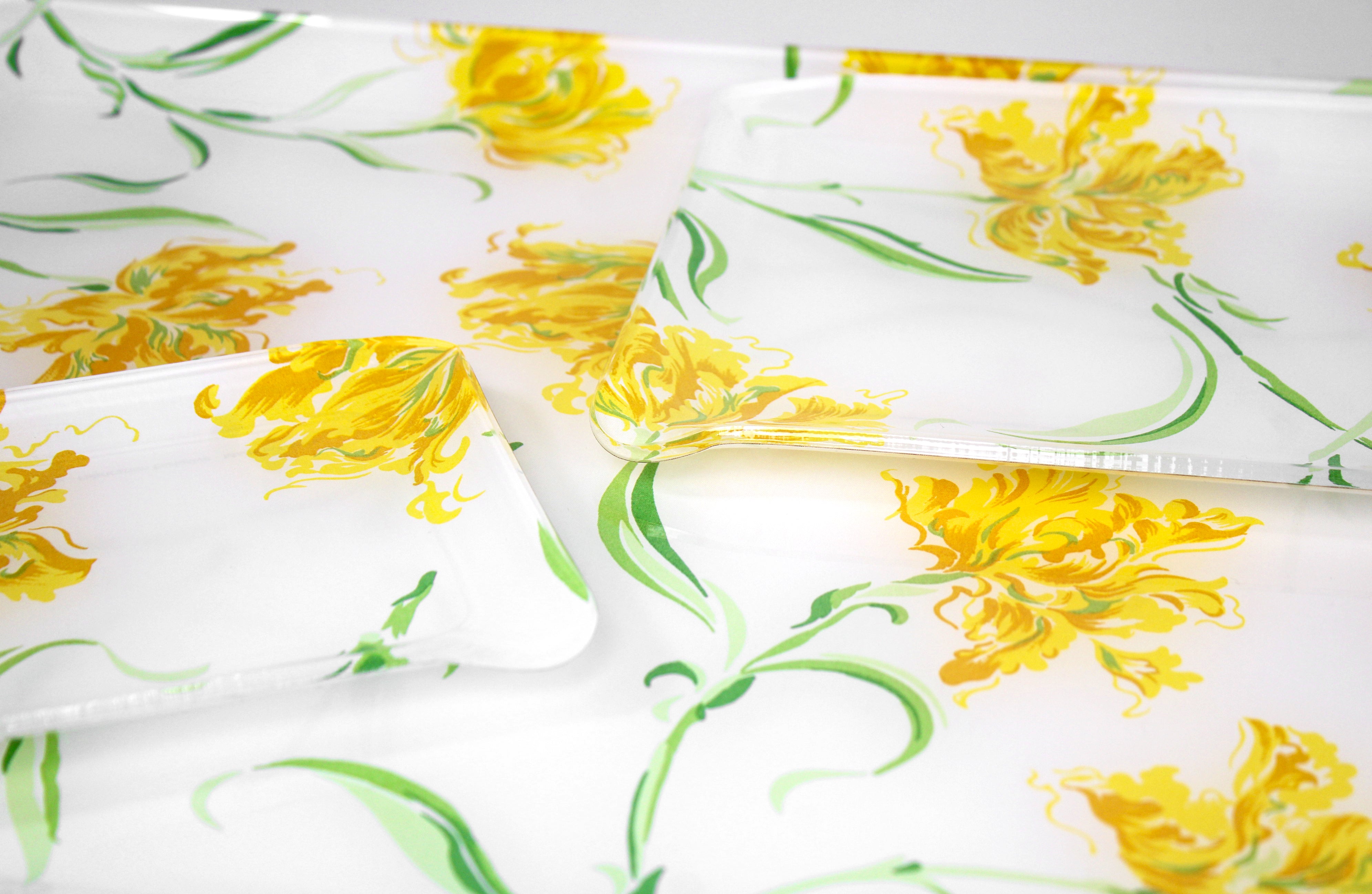 Printed Laminated Trays, side view of small and medium size trays on top of large tray. Each tray in yellow florals with green leaves/stems, Tulipe Perroquet print.