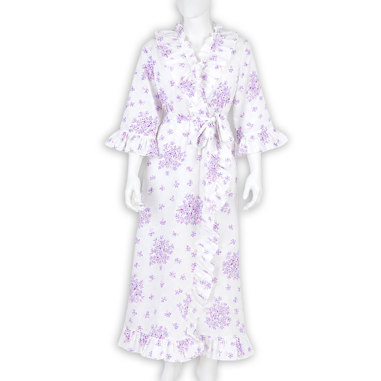 Lilac florals on cotton voile bias cut long nightgown with waist tie and V-neck, ruffles in front, back and on sleeve cuffs. Displayed on mannequin with a white background.