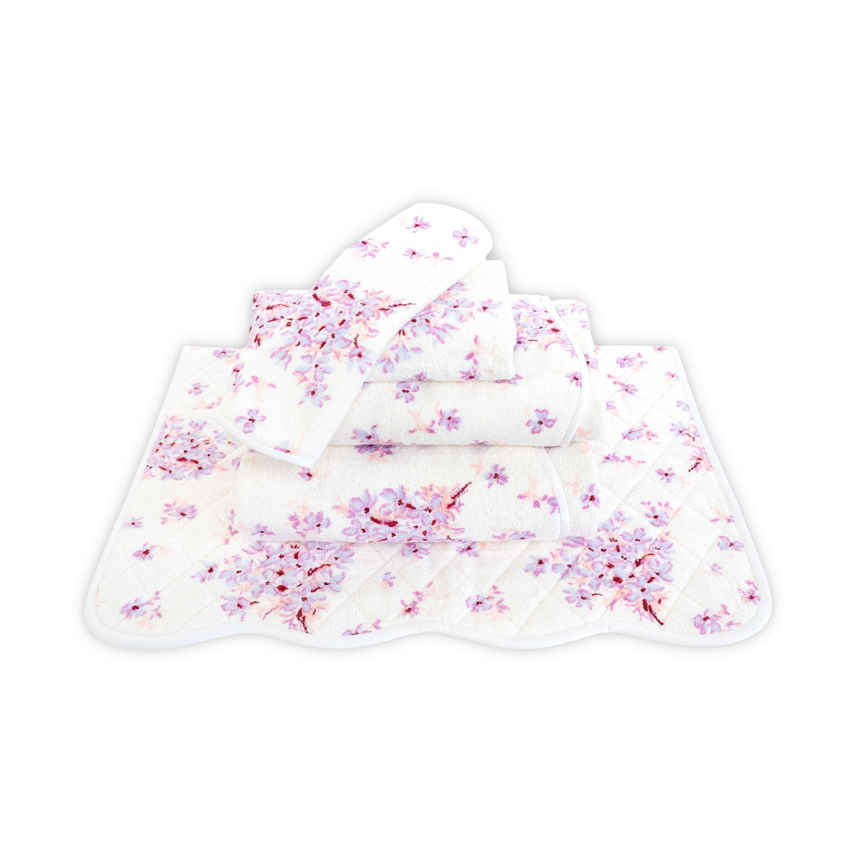 Printed violet and pink floral print, Folded Towel stack. Showing 1 of each size, from bottom to the top: Bathmat, Bath Sheet, Bath Towel, Hand Towel and Washcloth on a solid white background.