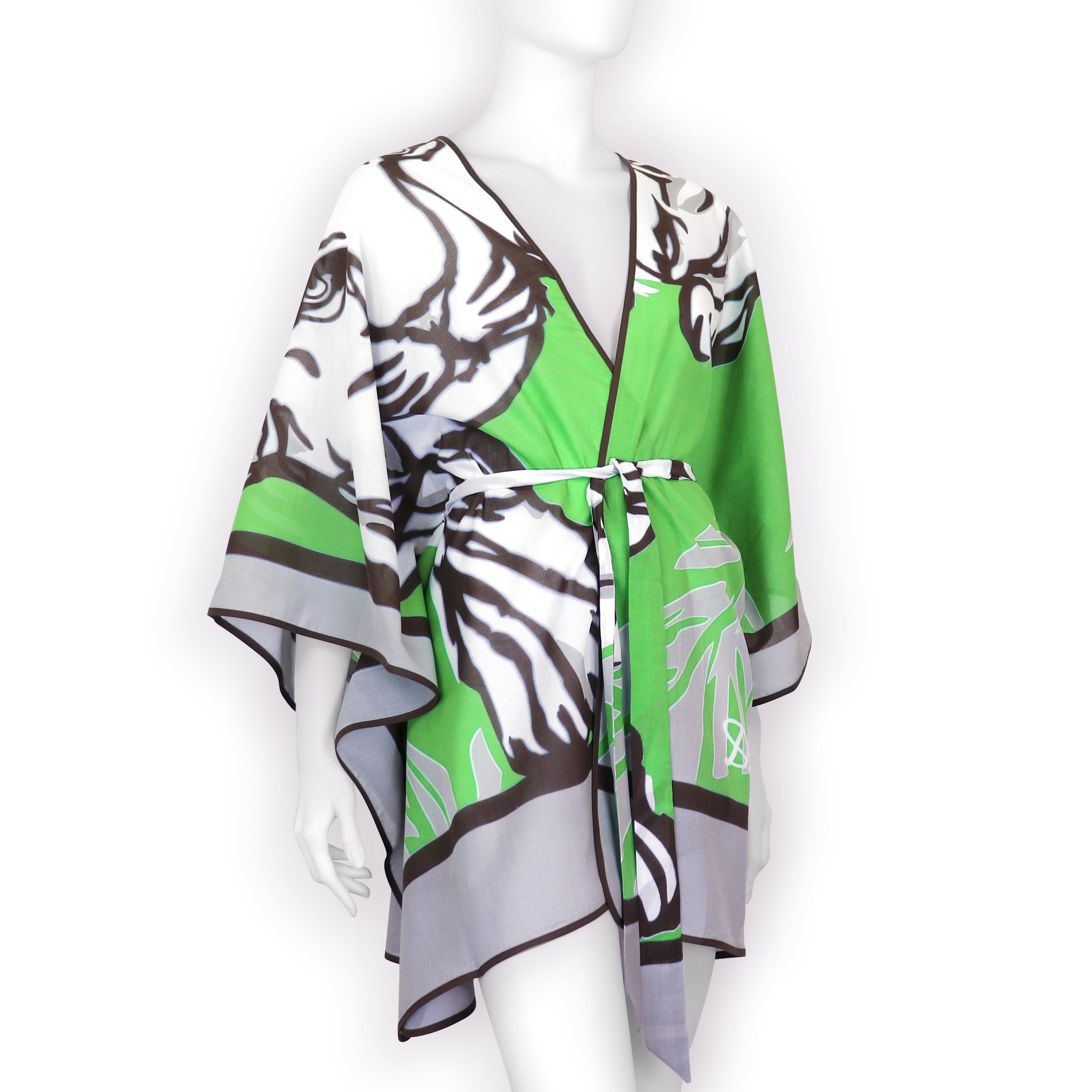 A hand-printed cotton voile kaftan with a tiger design in green and brown colors, displayed on a mannequin.